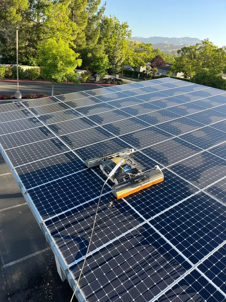 Robotic solar panel cleaner working a carport array at a Danville medical office