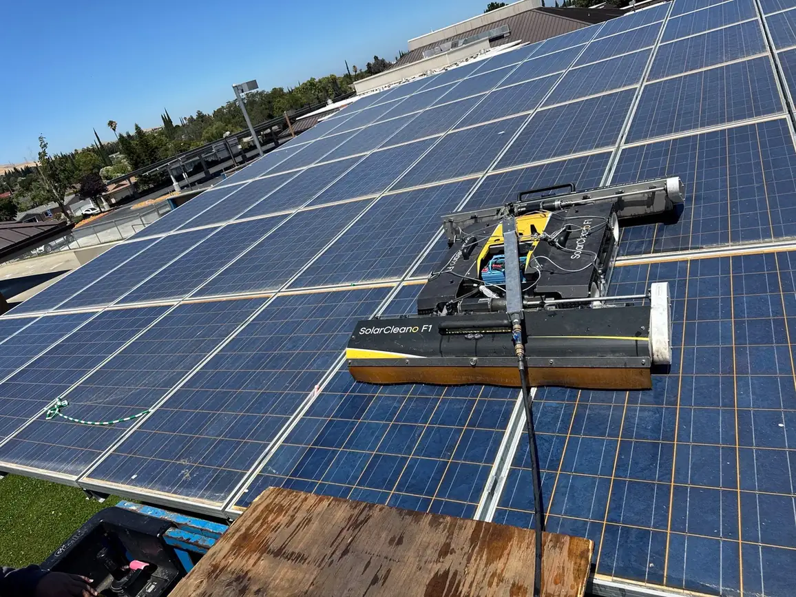 Robotic cleaner working on a school solar carport array in Pittsburg, CA